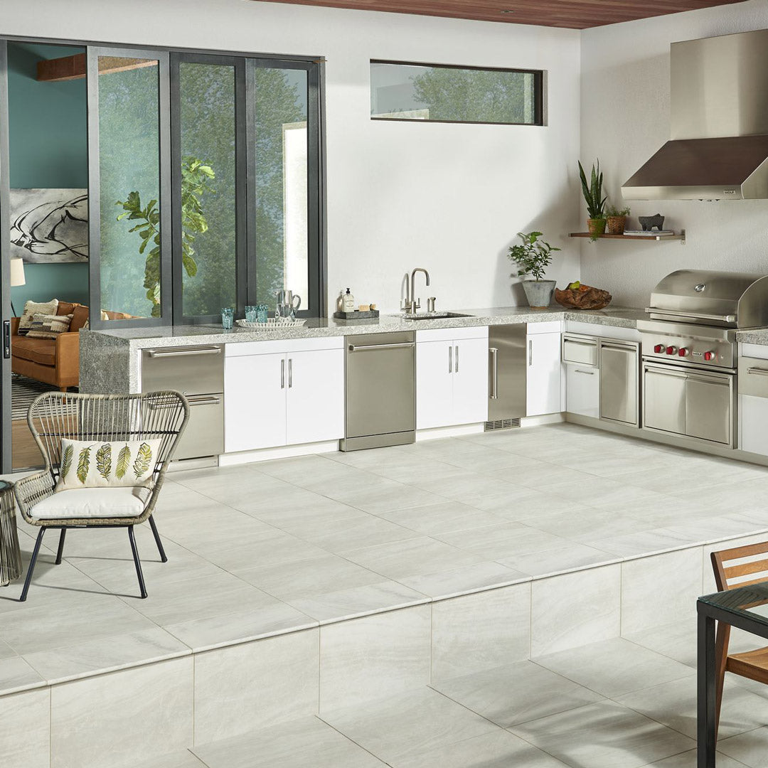 Modern outdoor kitchen with stone countertops and tile flooring