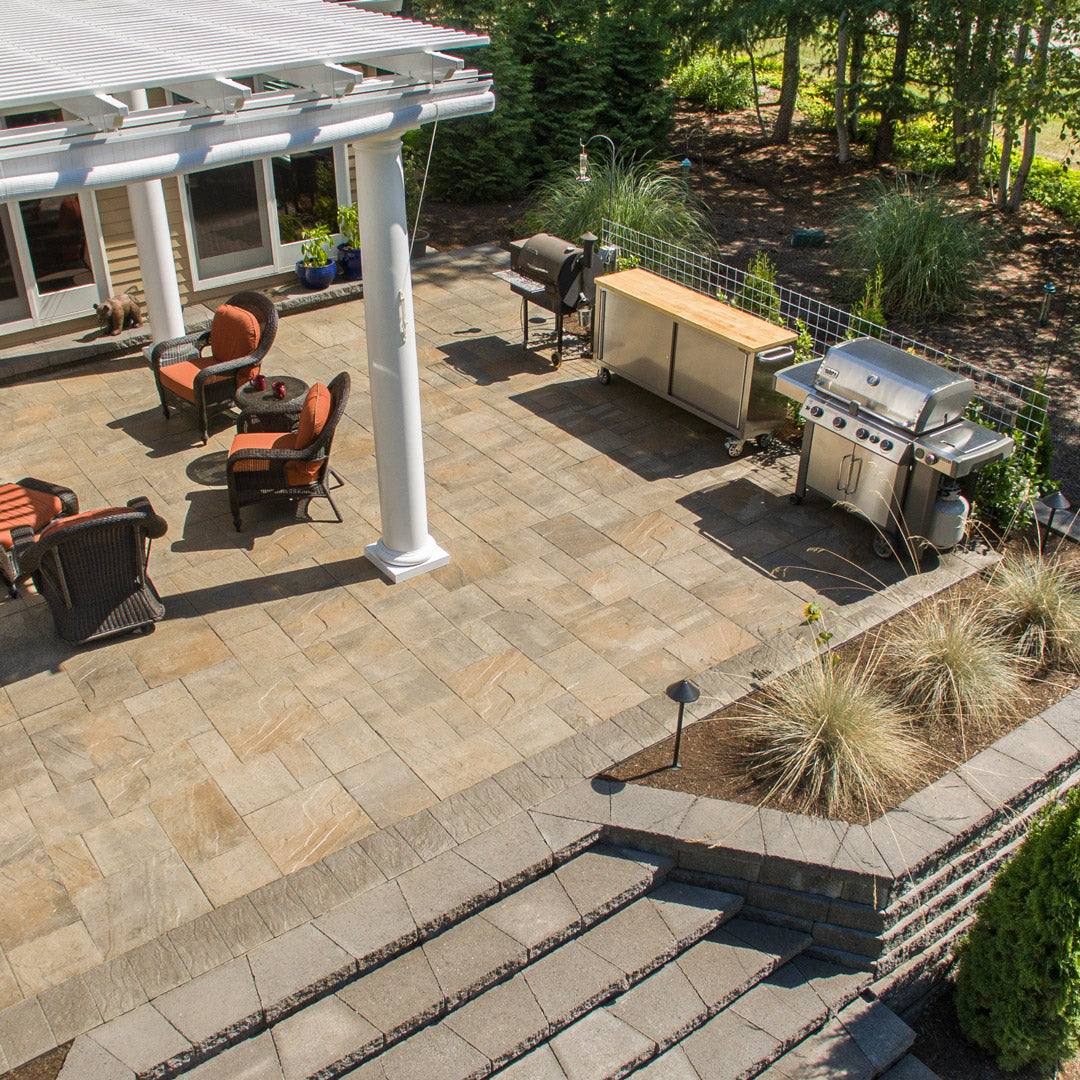 Outdoor patio area with stone pavers and steps