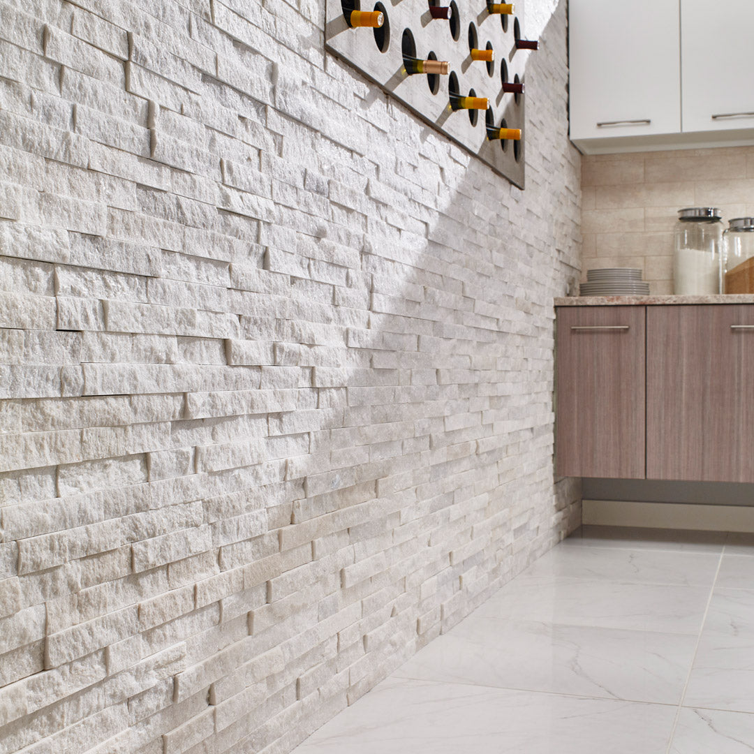 Kitchen interior with stone veneer wall.