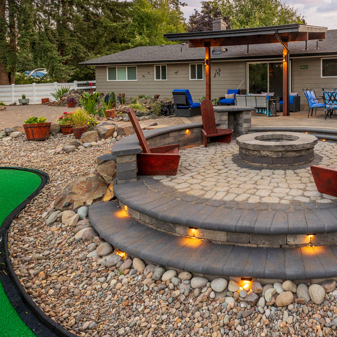 Outdoor patio with fire pit, seating area, and xeriscaped backyard