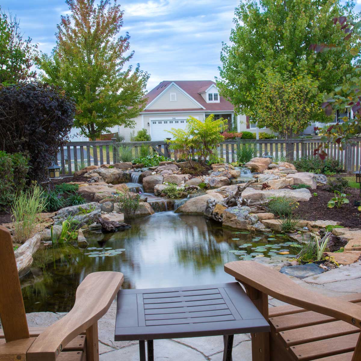 Backyard with a pond and stones on a stone patio