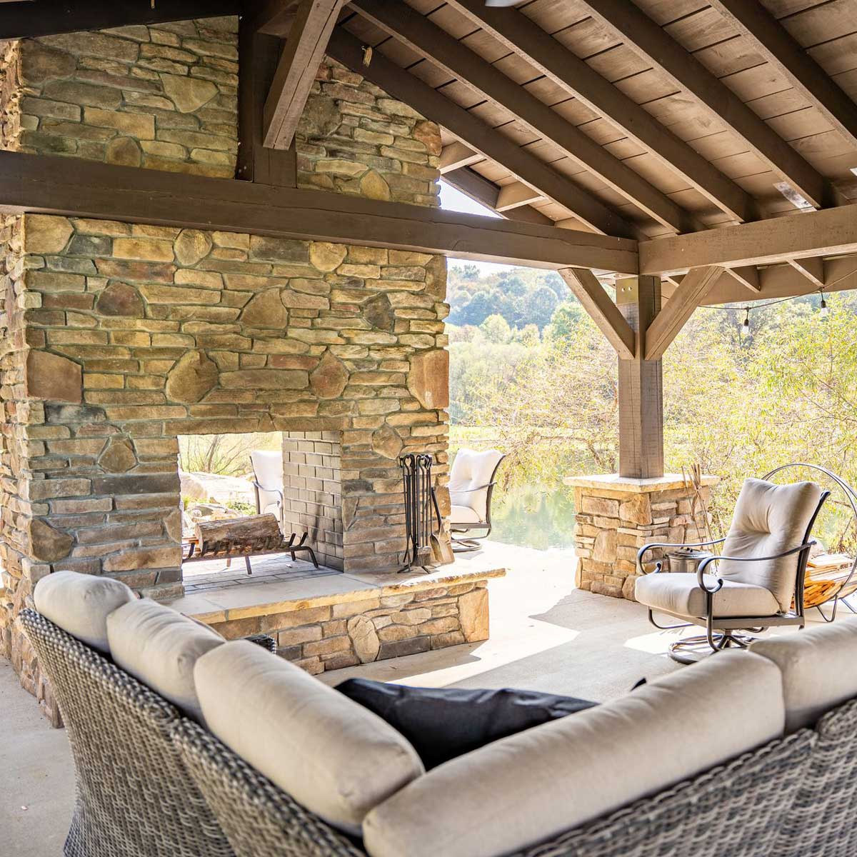 Outdoor patio with stone veneer fireplace